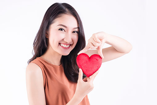 woman holding red heart woman holding red heart
